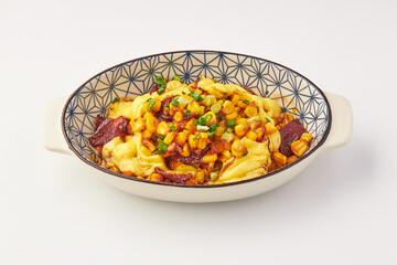 Delicious baked dish featuring creamy melted cheese, sweet corn, crispy bacon, and fresh green onions served in patterned ceramic bowl. Perfect for comfort food lovers