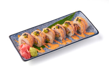 Sushi roll with fresh seafood, avocado, and rice, topped with spicy mayo and garnished with wasabi, pickled ginger, and tobiko, served on decorative plate