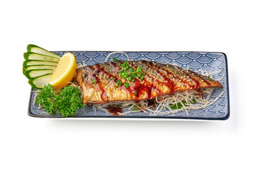 Grilled mackerel fillet with teriyaki sauce, garnished with green onions, served on decorative plate with sliced cucumber, lemon wedge, parsley, and shredded radish