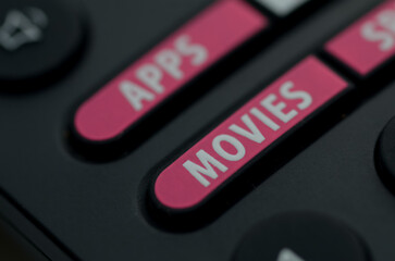 Close-Up of Remote Control Featuring Pink APPS and MOVIES Buttons
