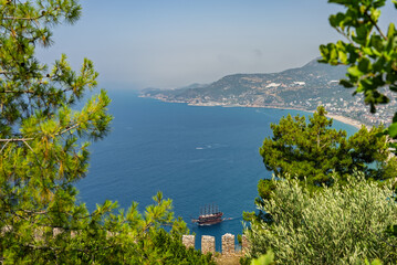 Drone view of Alanya city, Turkey. Coastline, Mediterranean Sea, harbor, historic castle on the...