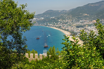 Drone view of Alanya city, Turkey. Coastline, Mediterranean Sea, harbor, historic castle on the...