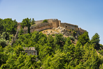 Drone view of Alanya city, Turkey. Coastline, Mediterranean Sea, harbor, historic castle on the...