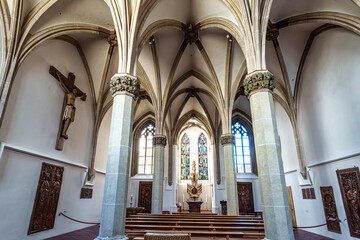 Fototapeta premium St. Stephans cathedral in Passau, Germany is an old white church with green metal domes on top of the towers