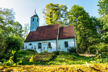 Church St.Clemens in Kranzberg near Freising, Bavaria with ancient graveyard and beautiful old...