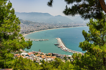 Drone view of Alanya city, Turkey. Coastline, Mediterranean Sea, harbor, historic castle on the...