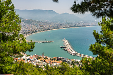Drone view of Alanya city, Turkey. Coastline, Mediterranean Sea, harbor, historic castle on the...