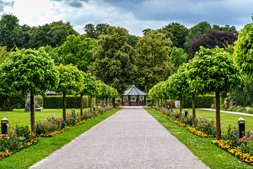 The Botanical Garden of Augsburg in Germany with garden pathes and topiary boxwood bushes on green...