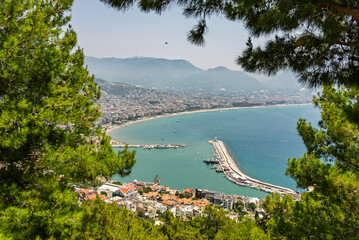 Drone view of Alanya city, Turkey. Coastline, Mediterranean Sea, harbor, historic castle on the...