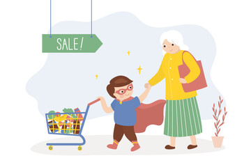 Little boy helping grandmother push shopping trolley, kids good manners concept. Boy helper and aged woman. Happy kid wearing super hero costume.