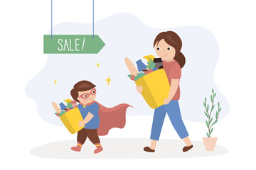 Little boy helping his mother carry shopping bags, kids good manners concept. Boy helper. Happy kid wearing super hero costume. Happy family after shopping.
