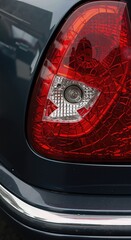 Close up of damaged car rear light. Broken vehicle after road accident. Automotive problem. Emergency automobile concept.