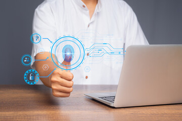 Biometric fingerprint authentication concept with man using secure login on laptop computer.