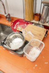 The sink as a silent witness to a festive dinner: stacked plates, glasses with traces of wine and...