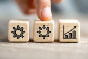 Hand placing a finger on a wooden block with a gear icon, alongside blocks with gears and growth chart