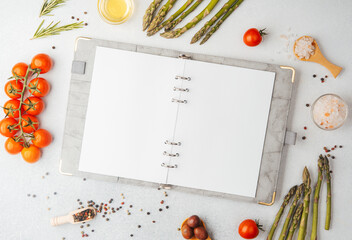 Blank recipe book with cooking ingredients on white background