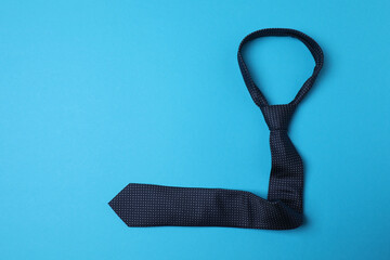 Father's Day. composition with gift box, glasses, cup of coffee and tie on blue background.
