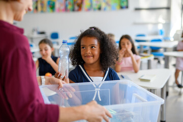 Young children learning about sustainability and ecology, sorting waste.