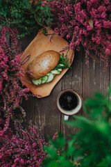Autumn snack with sandwich and black coffee