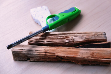 Green Utility Lighter and Firelighter Brick on Wooden Surface