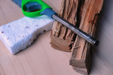 Green Utility Lighter and Firelighter Brick on Wooden Surface