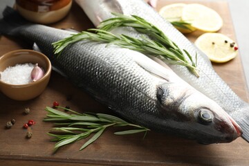 Fresh raw seabass with spices on table, closeup. Fish and seafood delicacies