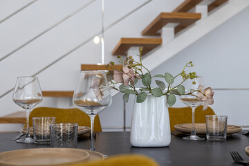 Elegant dining setup with flower vase