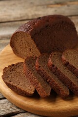 Pieces of fresh rye bread on wooden table, closeup