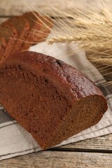 Pieces of fresh rye bread on wooden table, closeup