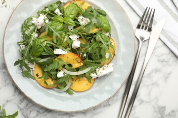 Tasty salad with arugula, cheese, peach and basil on white marble table, flat lay