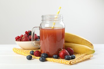 Superfood. Healthy drink in mason jar and ingredients on white wooden table against light grey background, closeup