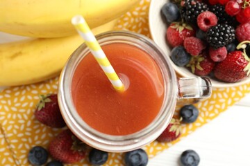 Superfood. Healthy drink in mason jar and ingredients on white table, flat lay