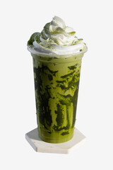 Iced matcha latte with whipped cream in plastic cup