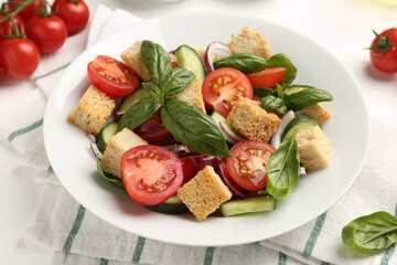 Delicious salad with croutons and ingredients on table, closeup