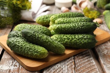 Making pickles. Fresh cucumbers and spices on wooden table, closeup