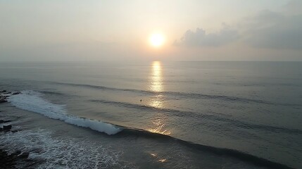Sunrise over ocean waves, tranquil coastal scene