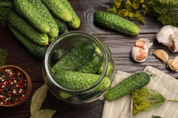 Making pickles. Fresh cucumbers and other ingredients on wooden table, flat lay