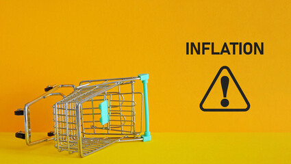 Consumer inflation is shown by upside down shopping cart. Grocery prices increase and Inflation...