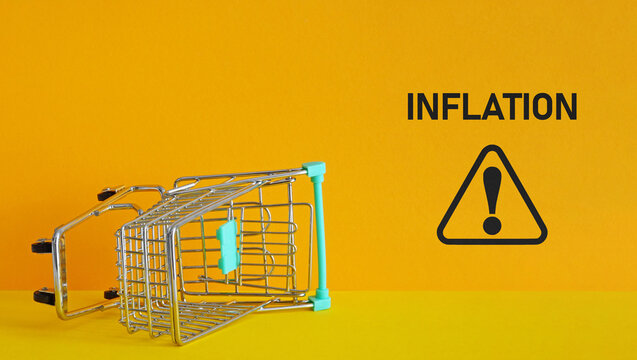Consumer inflation is shown by upside down shopping cart. Grocery prices increase and Inflation concept - Powered by Adobe