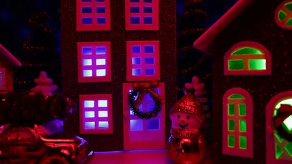 Close-up of a festive decorated town with colorful lights on a background with flying animation