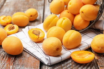 Fresh ripe apricots on wooden table, closeup