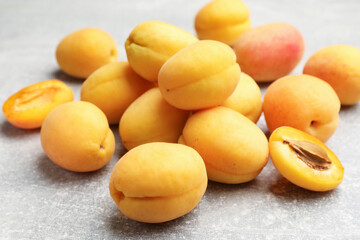 Fresh ripe apricots on grey table, closeup