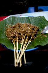 Sate Padang is a unique variant of Indonesian satay, from the Padang region, characterized by its distinctive yellow-brown, thick, and spicy sauce made from rice flour, various spices