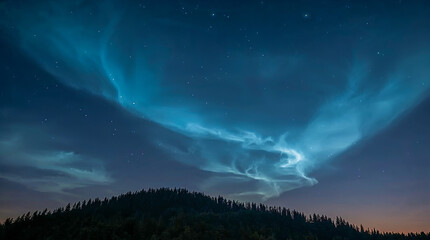 Fototapeta premium Electric blue noctilucent clouds illuminated by twilight, stretching across a starry night sky above a dark, silhouetted forest-covered hill.
