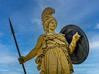 Athena, the Greek goddess of wisdom and knowledge, with a helmet, a sharp spear and a large shield....