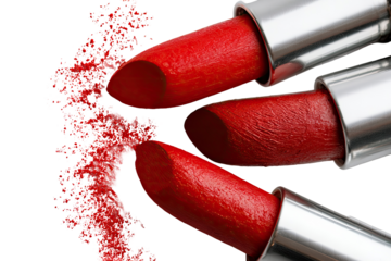 Close-up of several vibrant red lipsticks, with a splatter of product in a circular pattern.  Metal lipstick tubes are visible