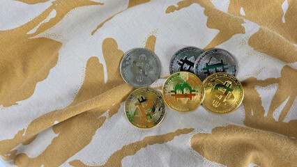 Colorful Bitcoin Tokens on Fabric Background