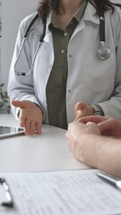 Doctor woman in medical coat is explaining diagnosis to male patient during a medical consultation...