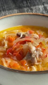 A bowl of shchi soup spins in a cafe. 