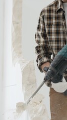 Close up of unrecognizable male construction worker wearing beige checkered shirt and protective...
